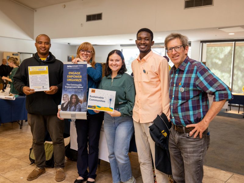 Students and faculty smiling at camera.