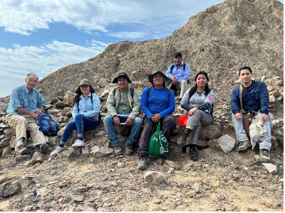 Students sitting on a mountain side.