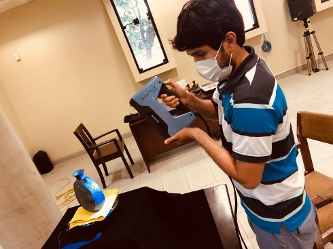 A student holding a piece of equipment.