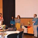 Faculty members standing up handing out awards.