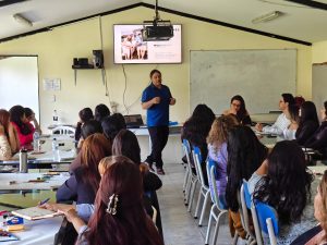 Noah Hayes-McKernan presenting to a group of students in front of a projector screen