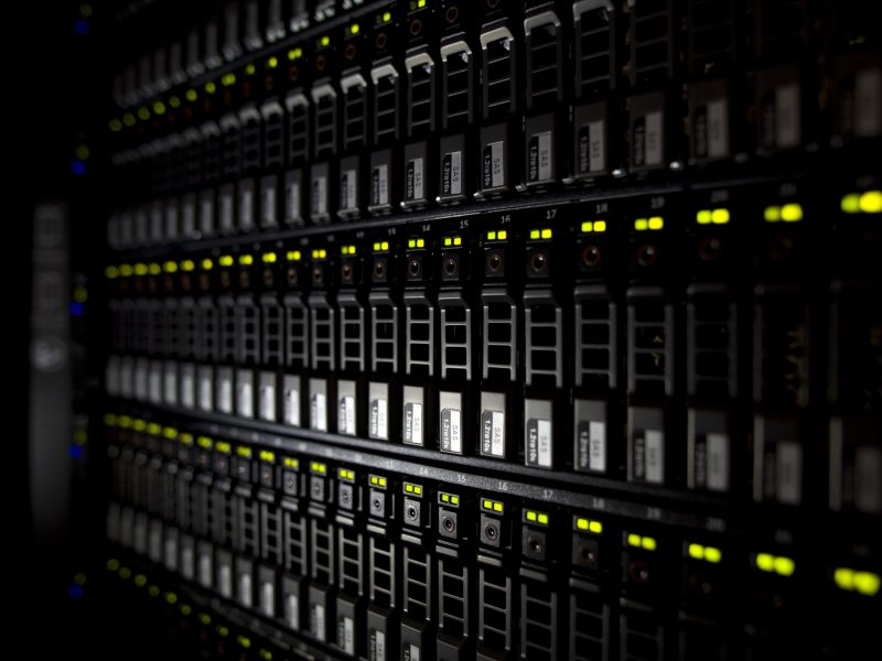 Backside of computer monitor with green lights.