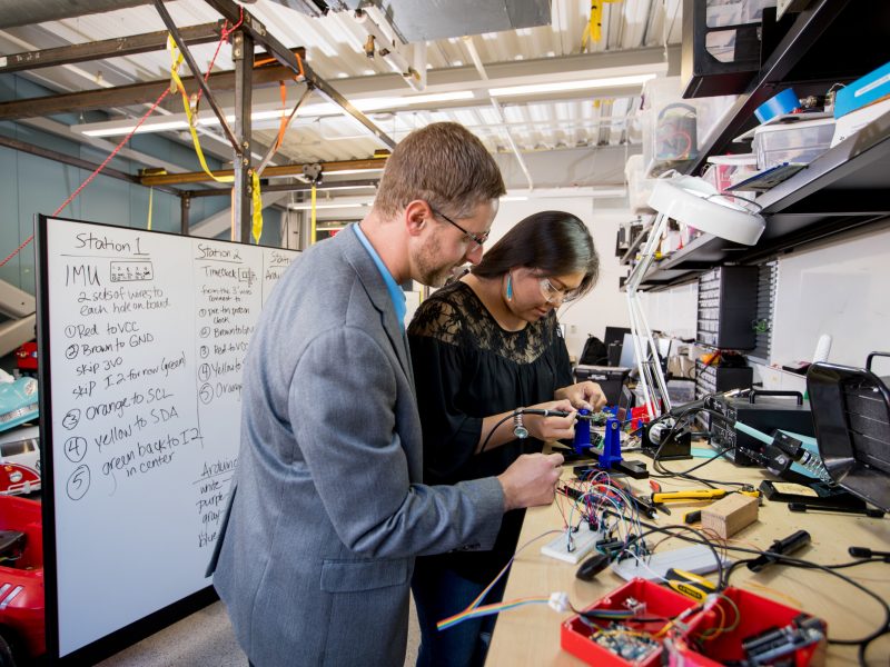 Researcher and student working in lab on computer software.