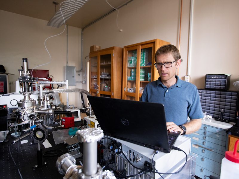 Researcher Mark Loeffler working in lab on a computer