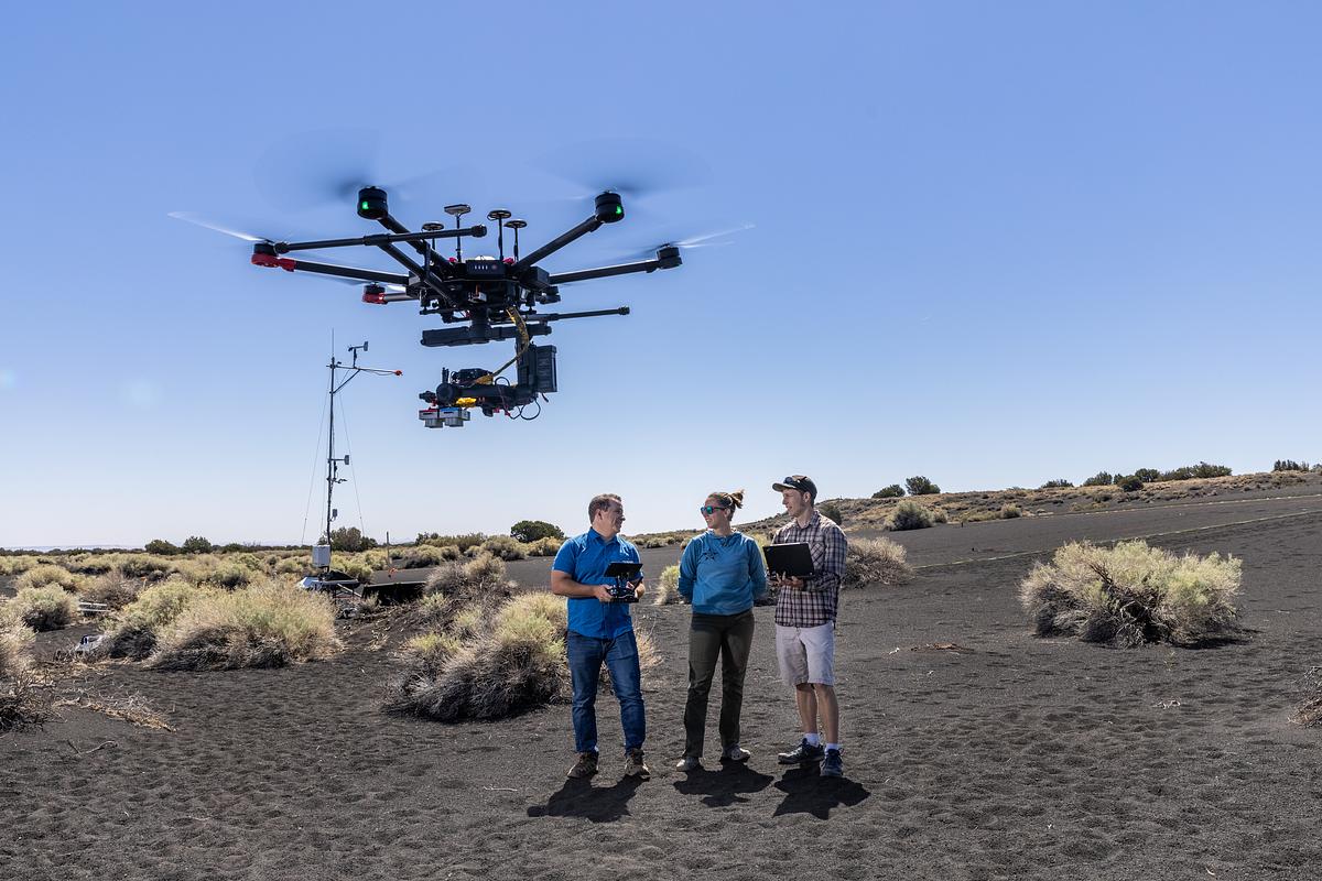 Christopher Edwards and students conducting research using a drone in northern Arizona at Sunset Crater.
