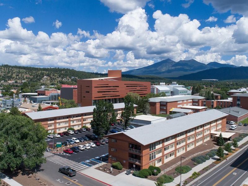 Ariel view of north campus at N A U. Several large buildings and the San Francisco peaks in the background.