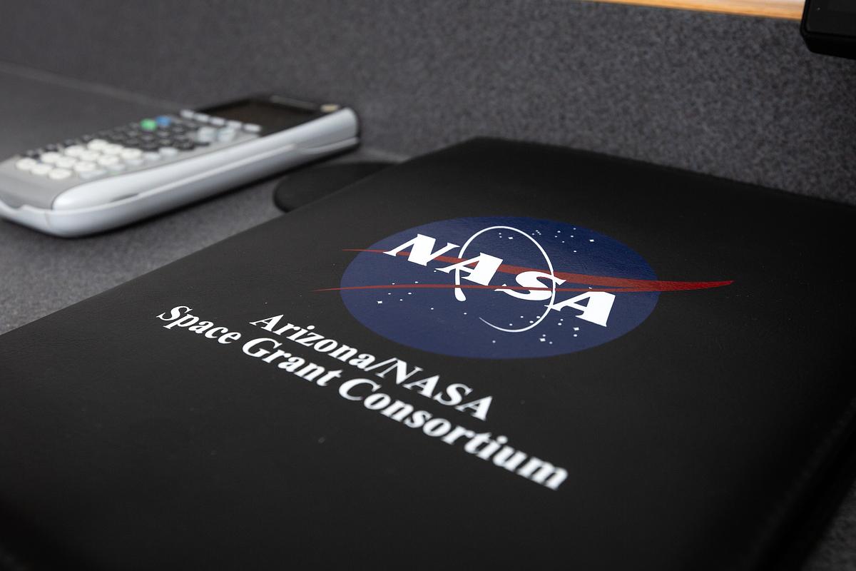NASA grant consortium folder laying on a desk.