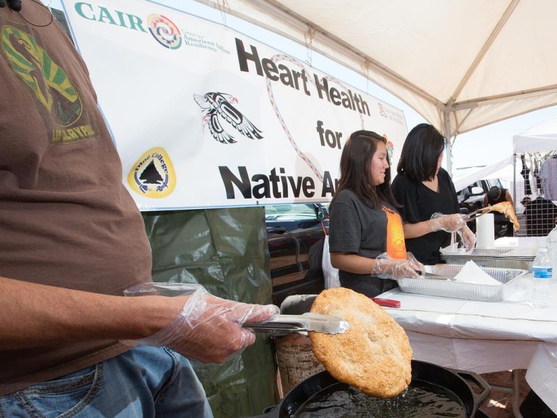 Three people making fry bread at healthy heart expo.