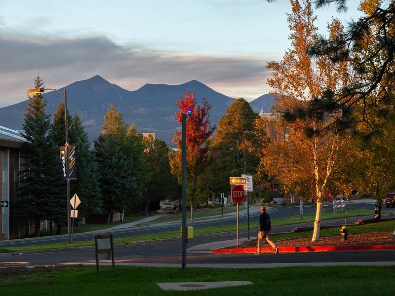 N A U campus with San Francisco peaks in background and trees with fall colors,