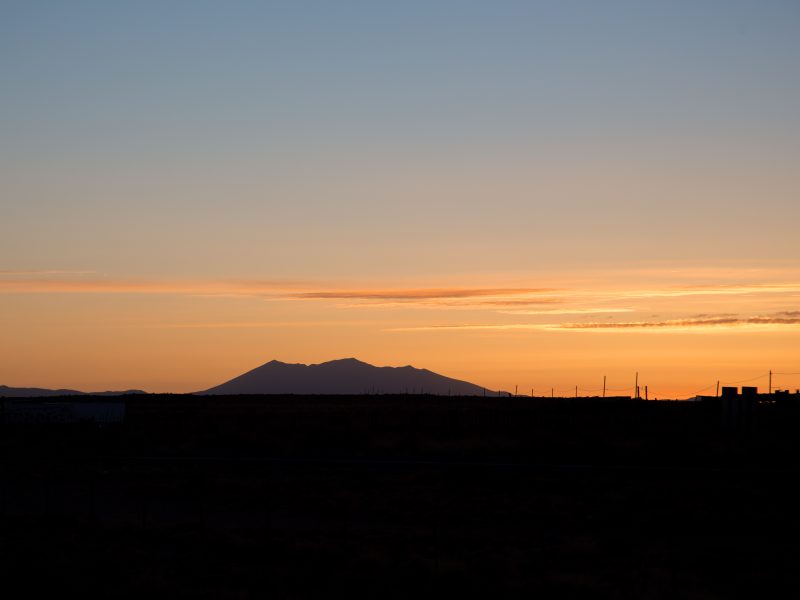 Sunset view with orange sky and dark San Francisco peaks.