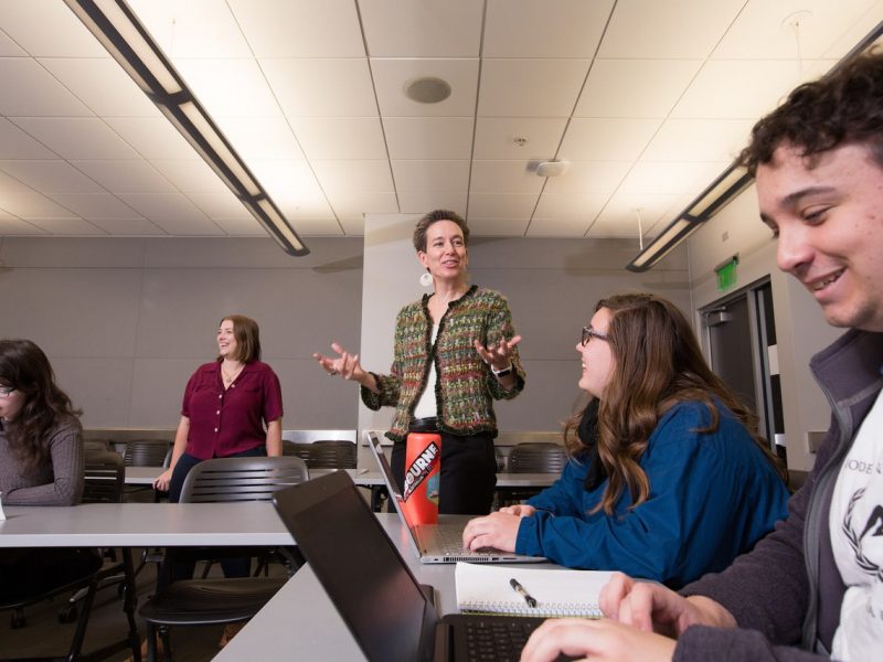 Professor lecturing students in a classroom.