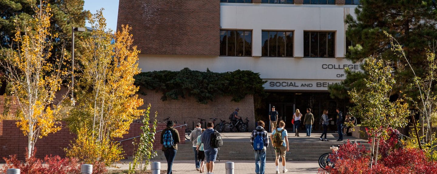 Students walking into the social and behavioral sciences building.