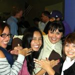 Students holding up hand signs.
