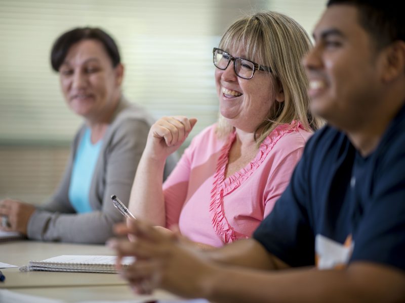 Students sitting in class and smiling.