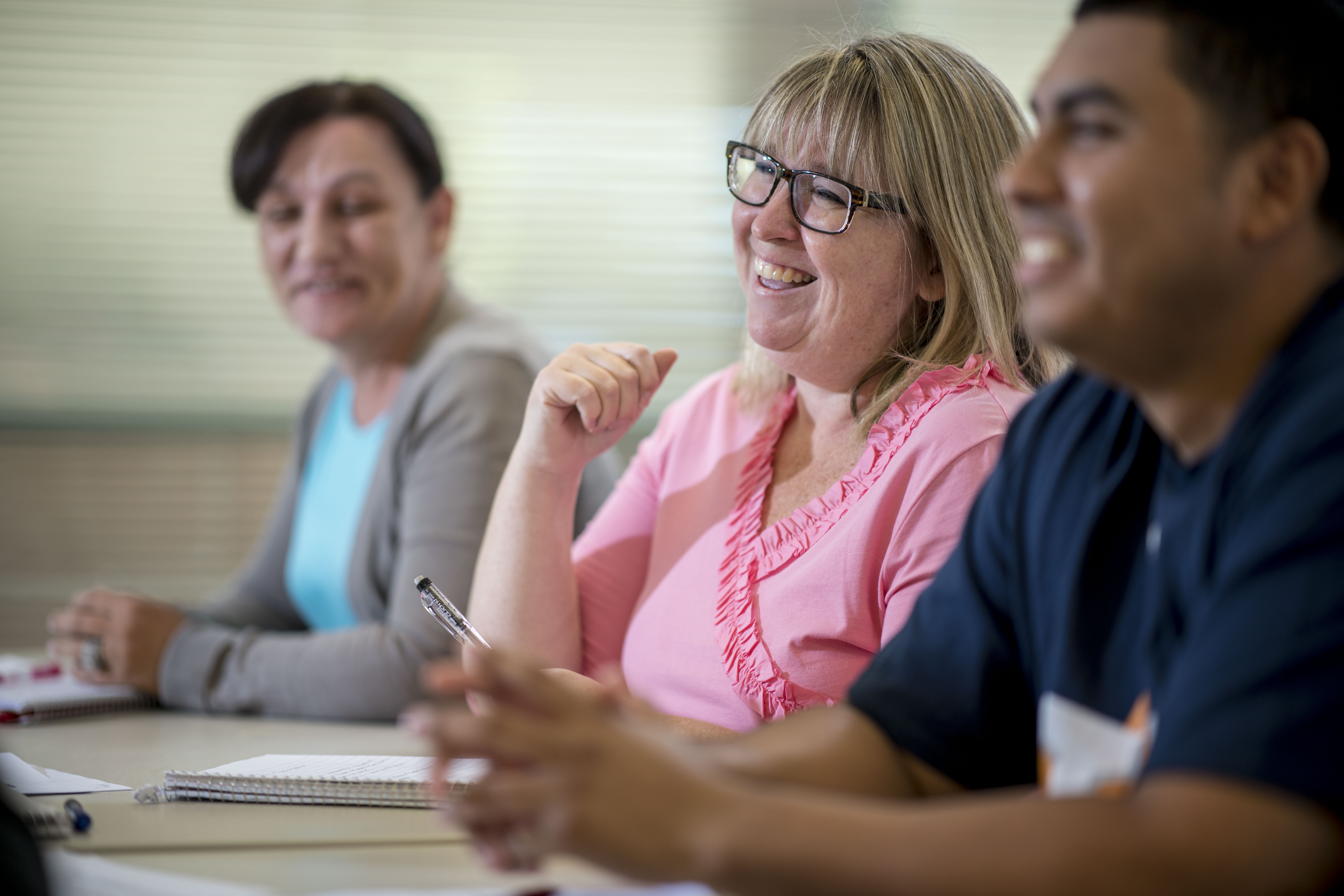 Students sitting in class and smiling.