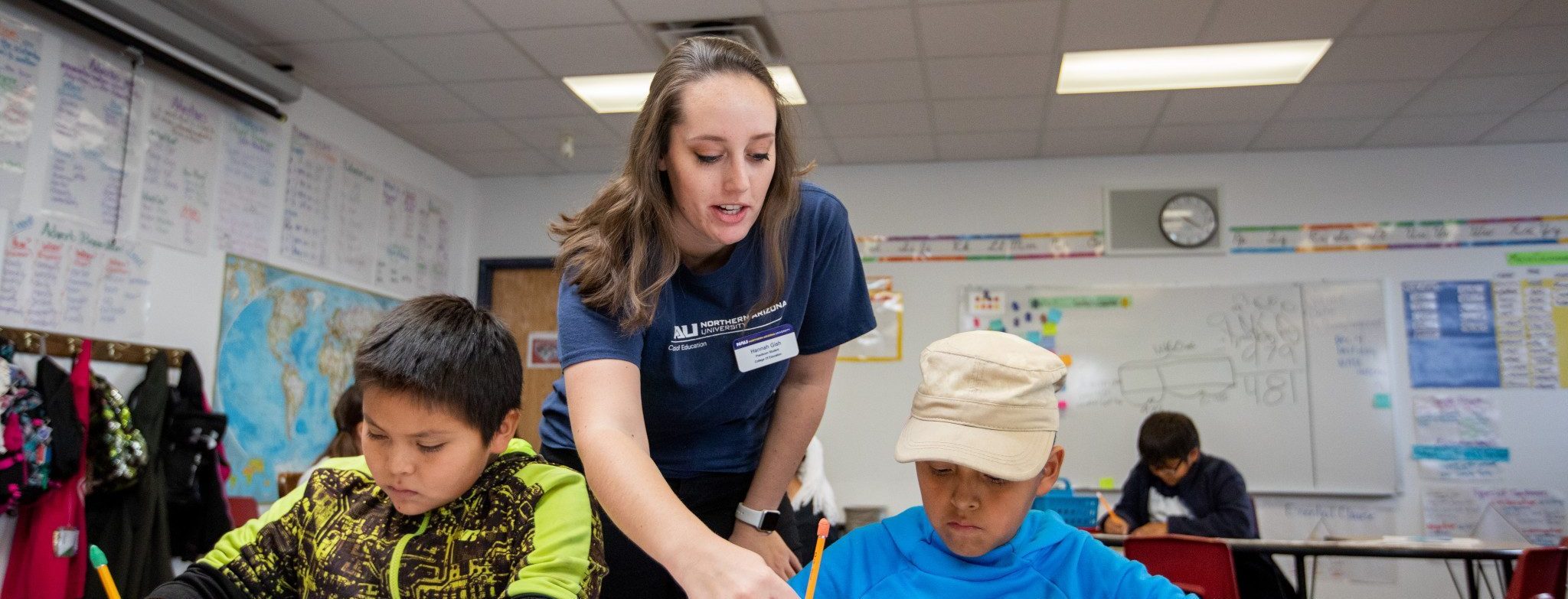 Student teacher helping a students with an assignment.