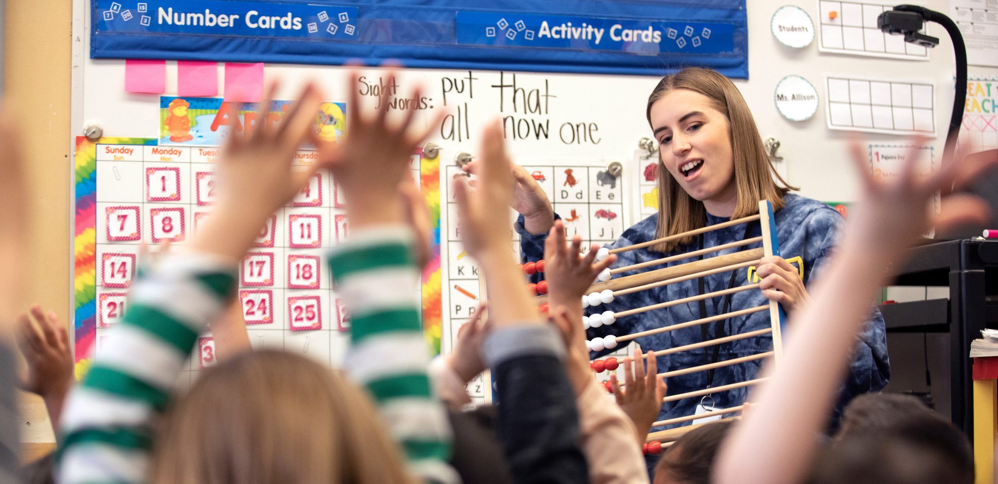 N A U student teacher sitting in front of students and teaching them.