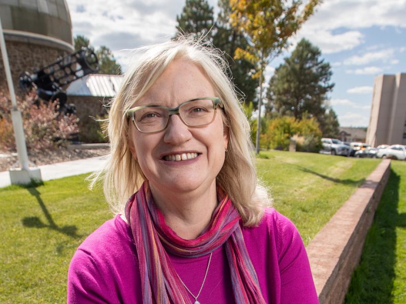 Marti Canipe sitting down and posing for camera.