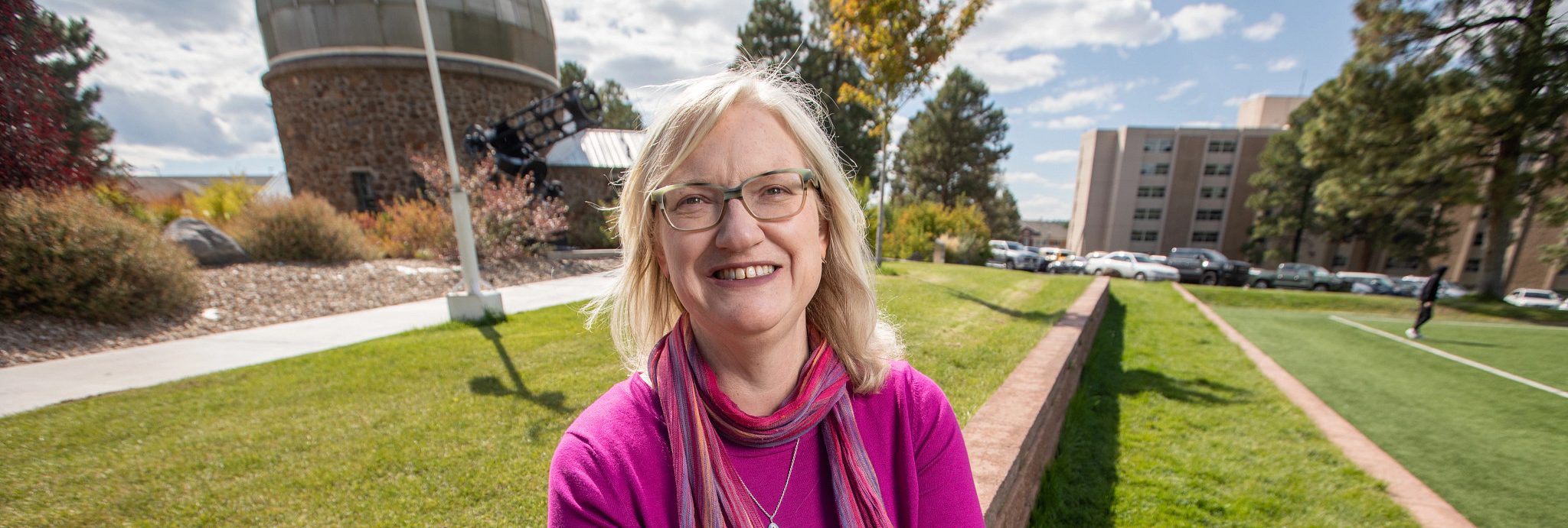 Marti Canipe sitting down and posing for camera.