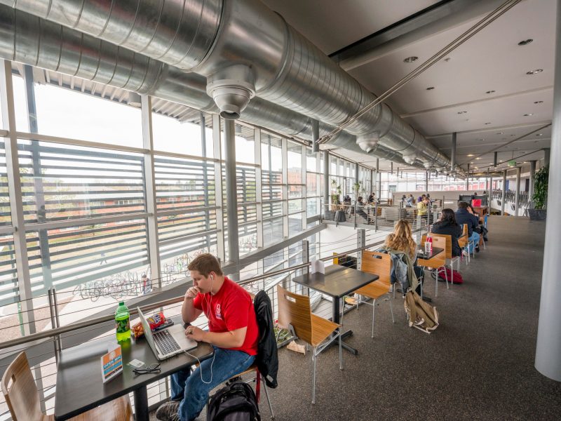 N A U students sitting at tables in the Student Union.