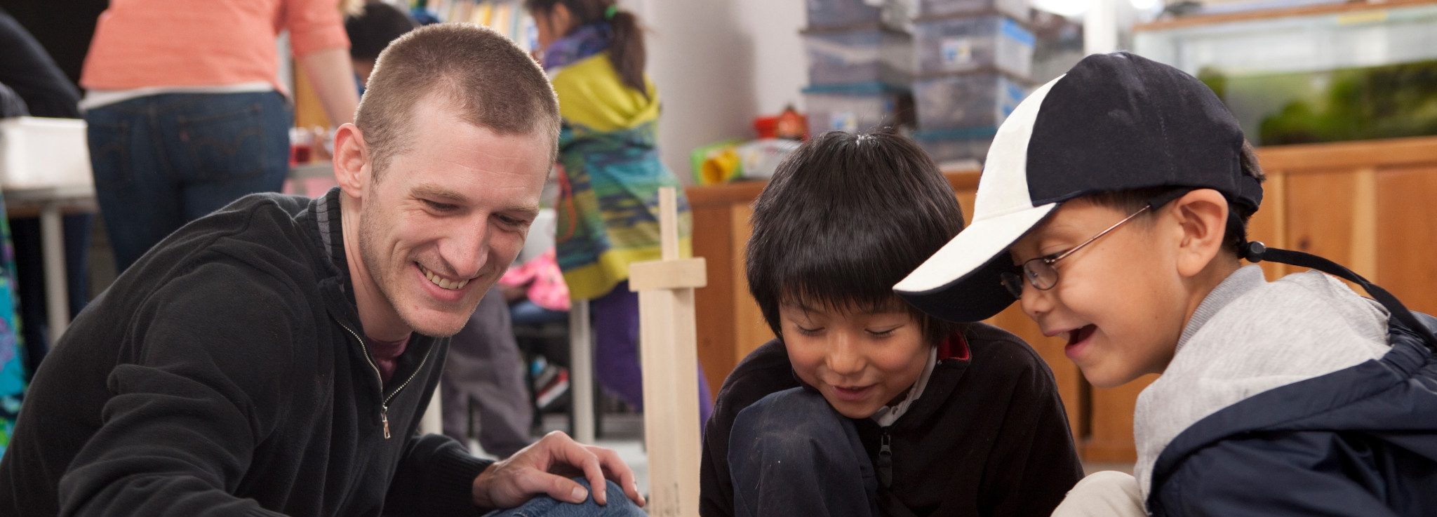 Student teacher playing a game with young students.