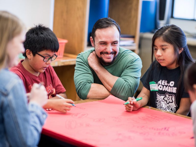 Student teacher working with young students.
