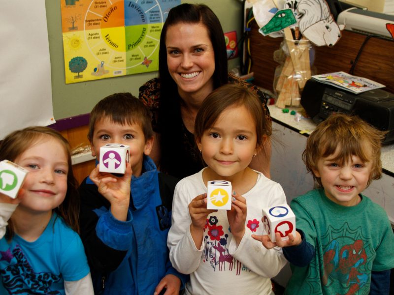 Student teacher works with young students.