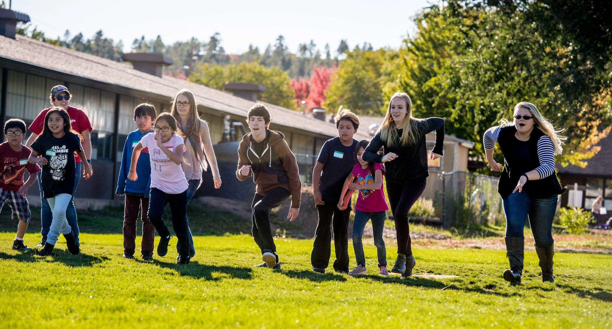 Student teachers running with young students.