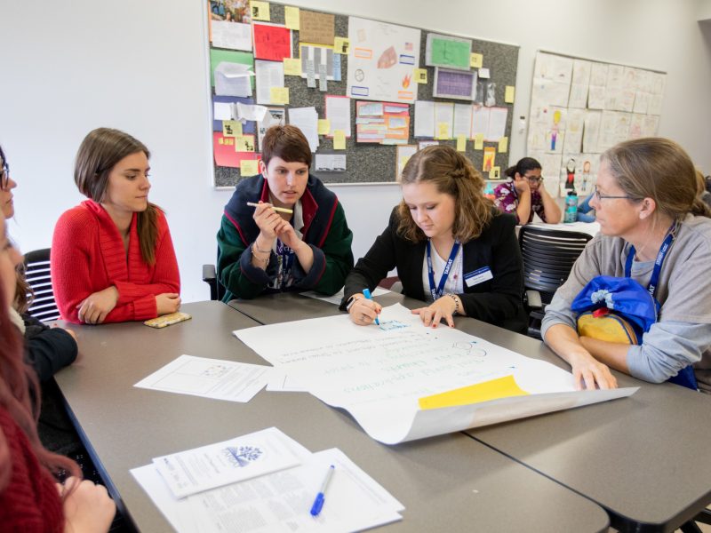 N A U students working together in a classroom.