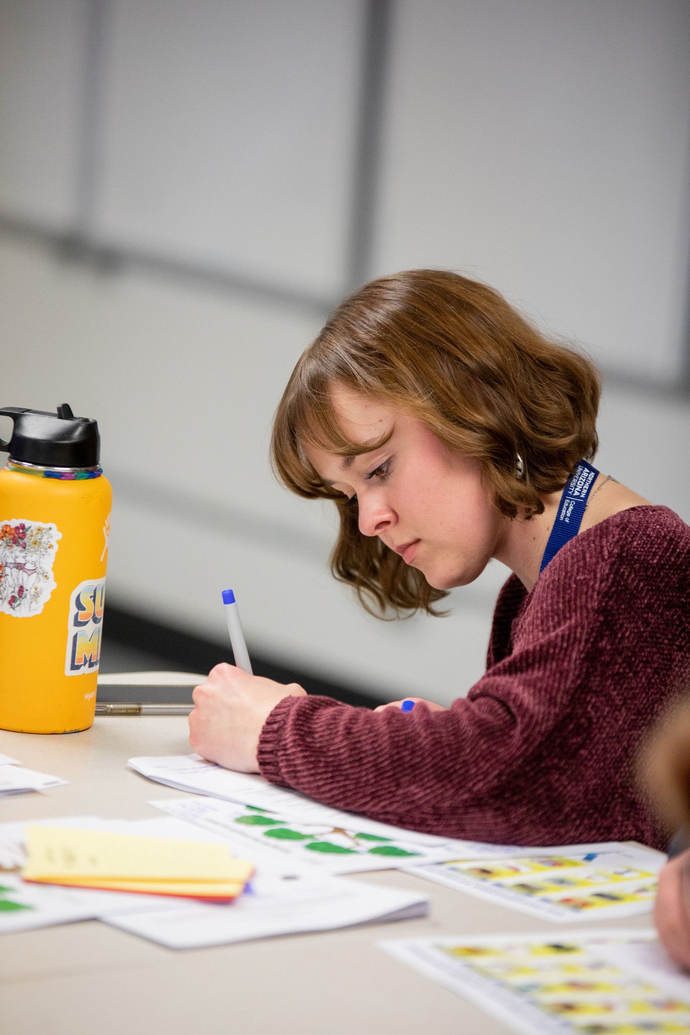N A U student taking notes in class.