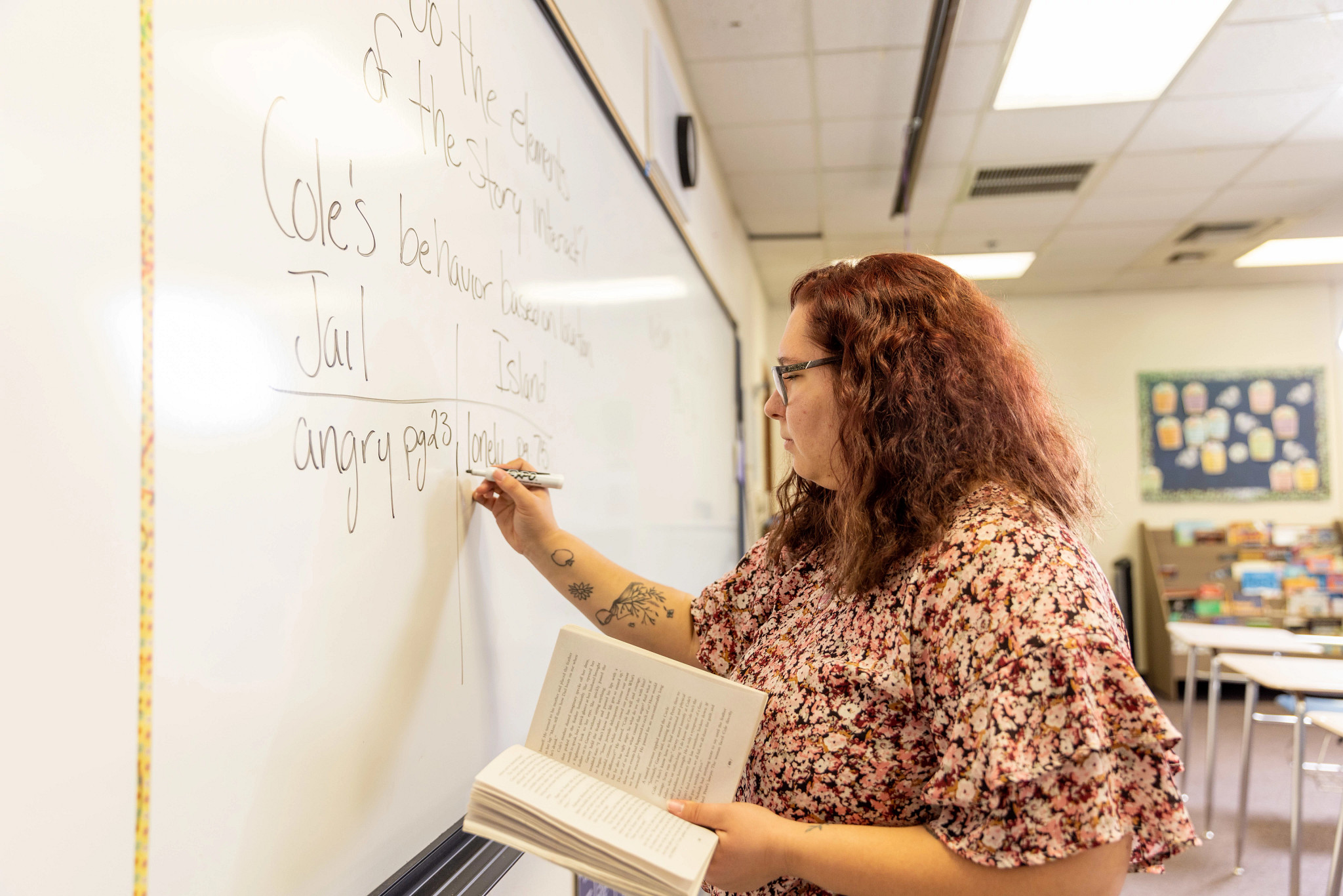 Student teacher writing on white board.
