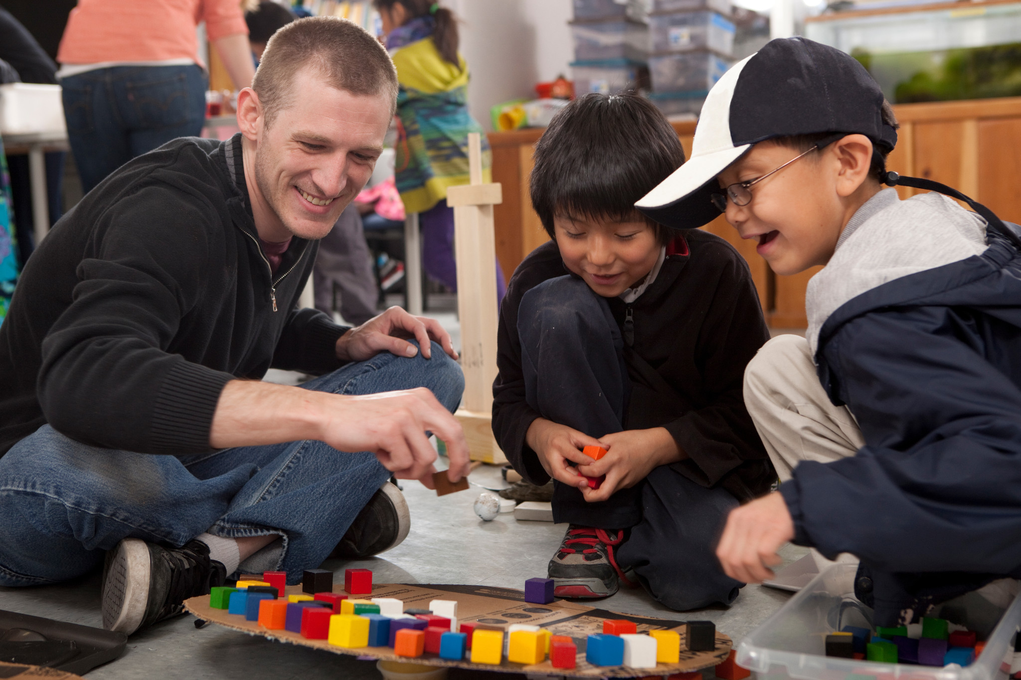 Student teacher plays game with young students.
