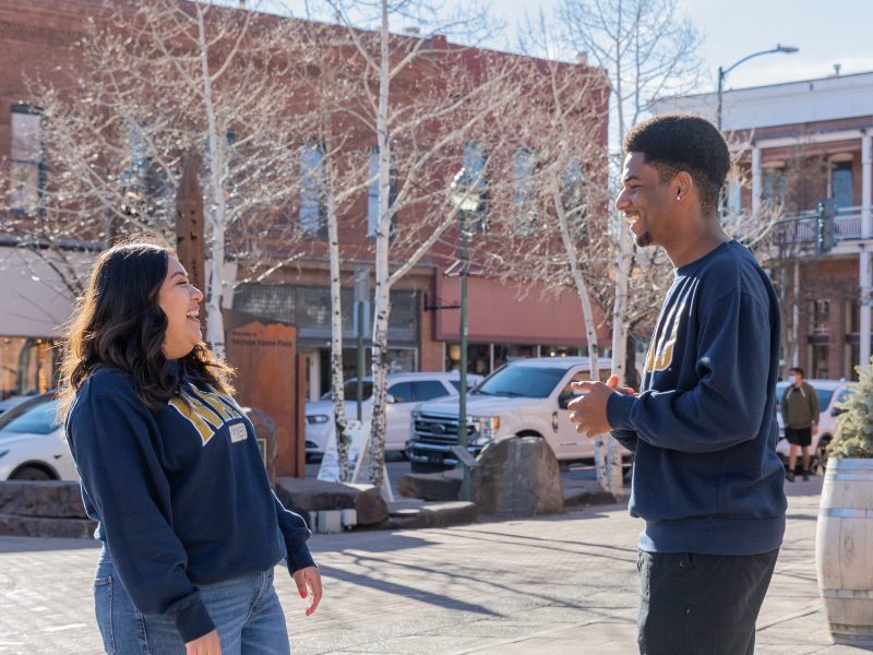 N A U students laughing in downtown Flagstaff.