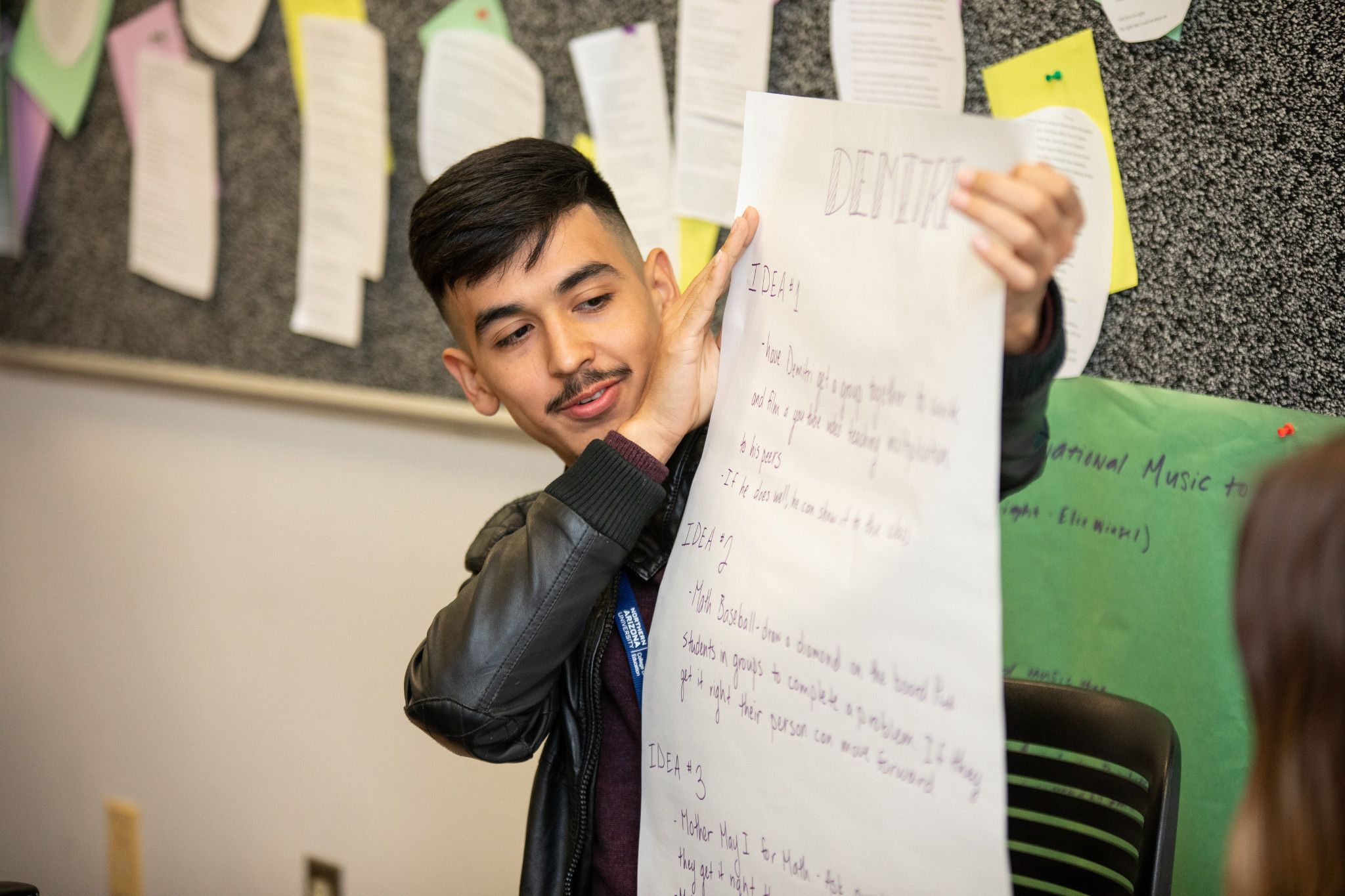 N A U student reads idea list to class.