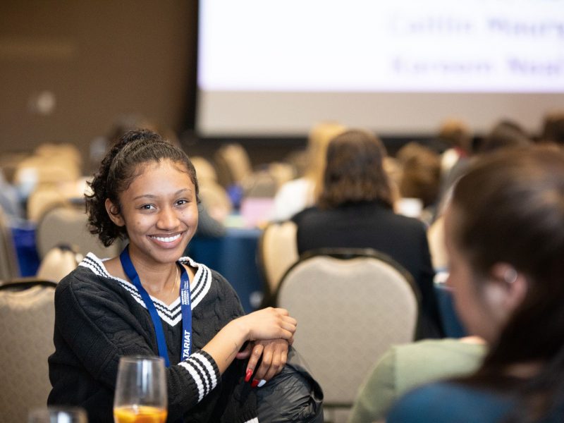 N A U student smiling at a banquet.