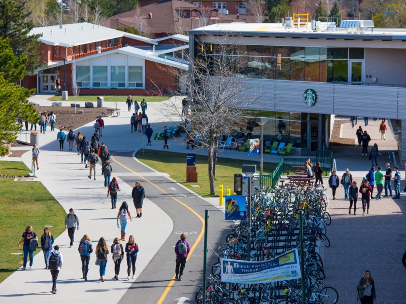 Students walking through campus next to the campus Starbucks.