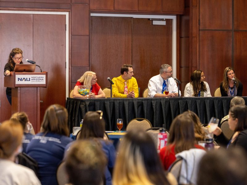 A panel of experts speaks to a crowd at N A U Tariat.