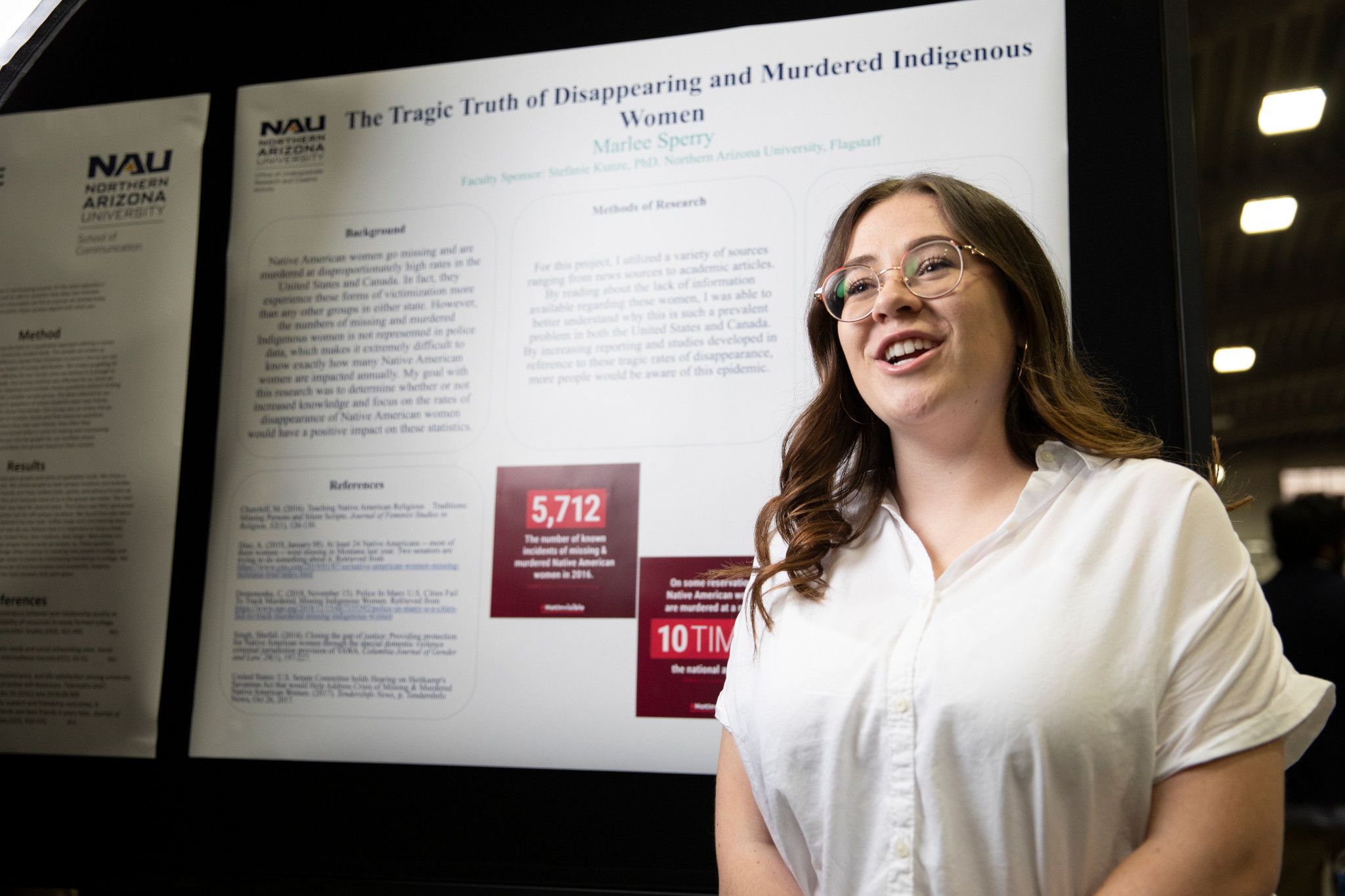 N A U College of Education student presenting at a symposium.