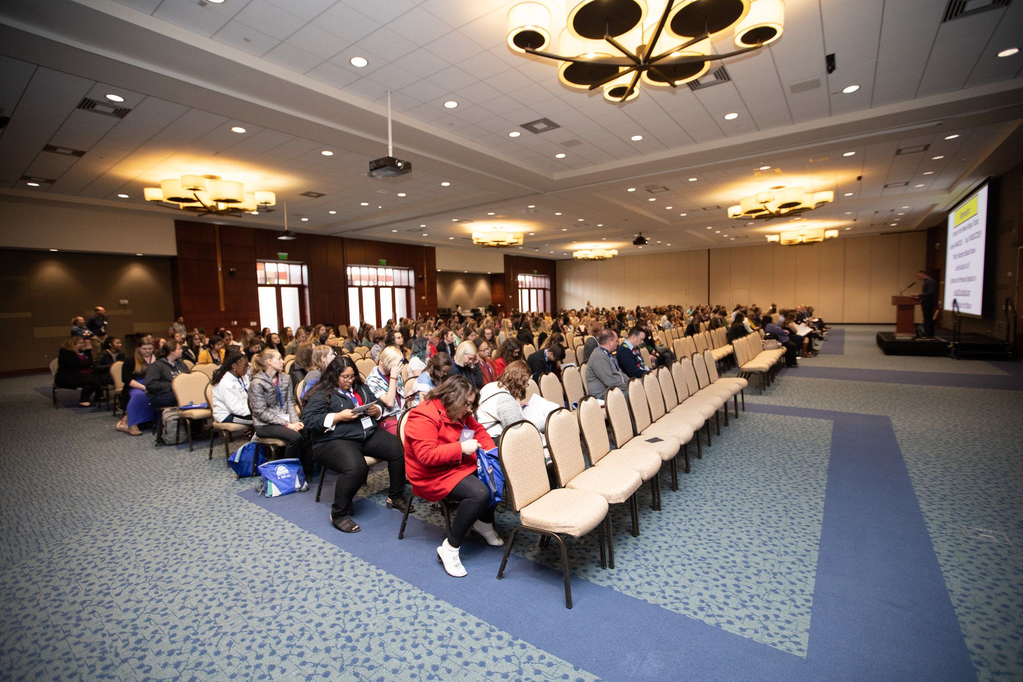 View of There's a Reason I am a Teacher conference, showing rows of seats and people waiting for the conference to begin.