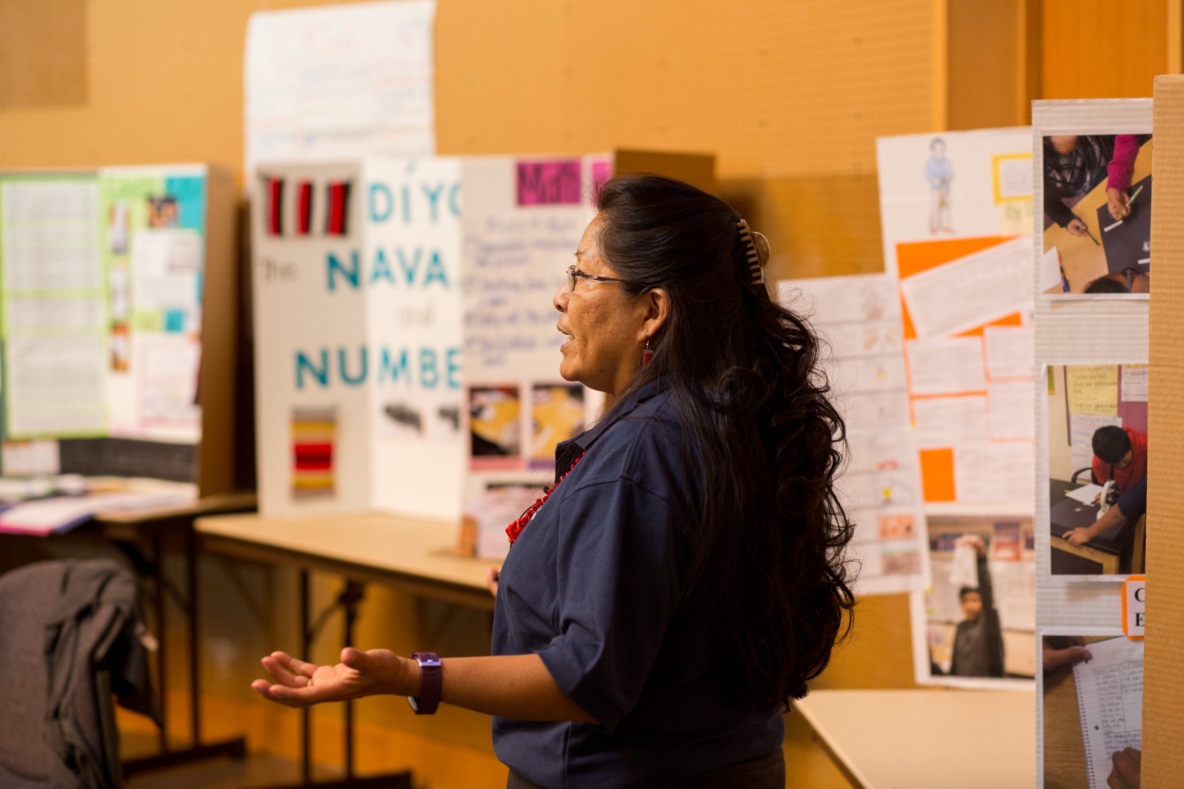 Shirley speaking in front of posterboards.