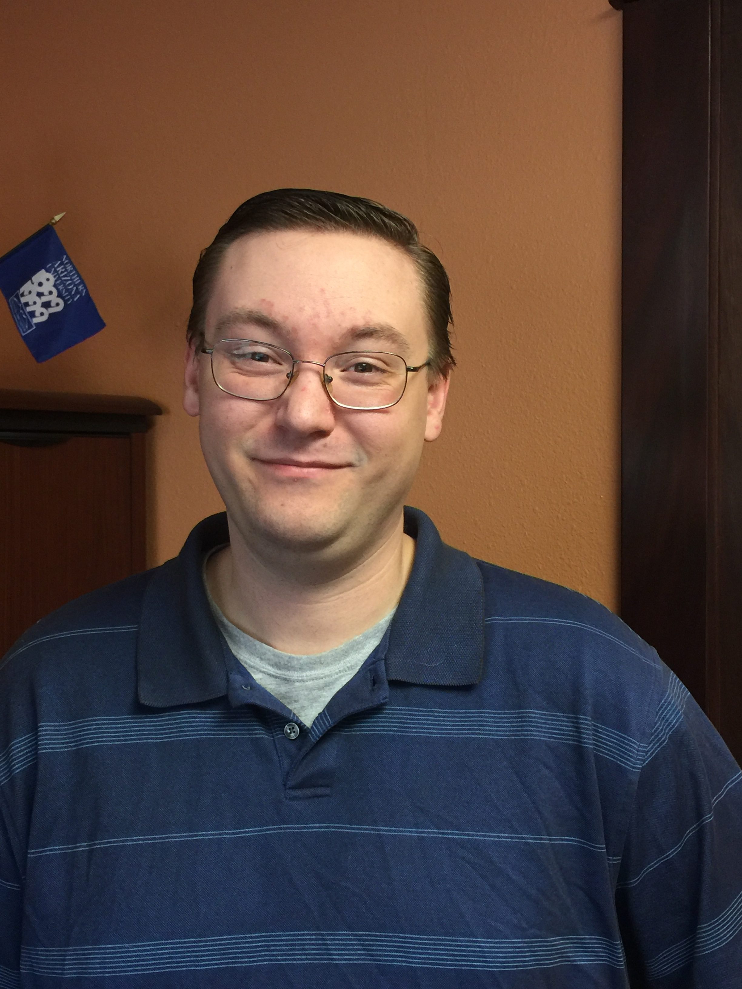 A headshot of Garrett Ellsworth, Operations Coordinator, Senior for the College of Education and the Cline Library at Northern Arizona University