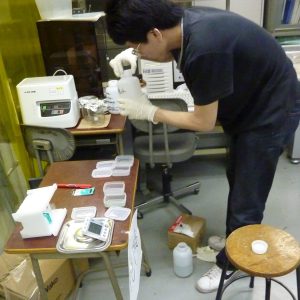 An NAU professor is working with ink and paper