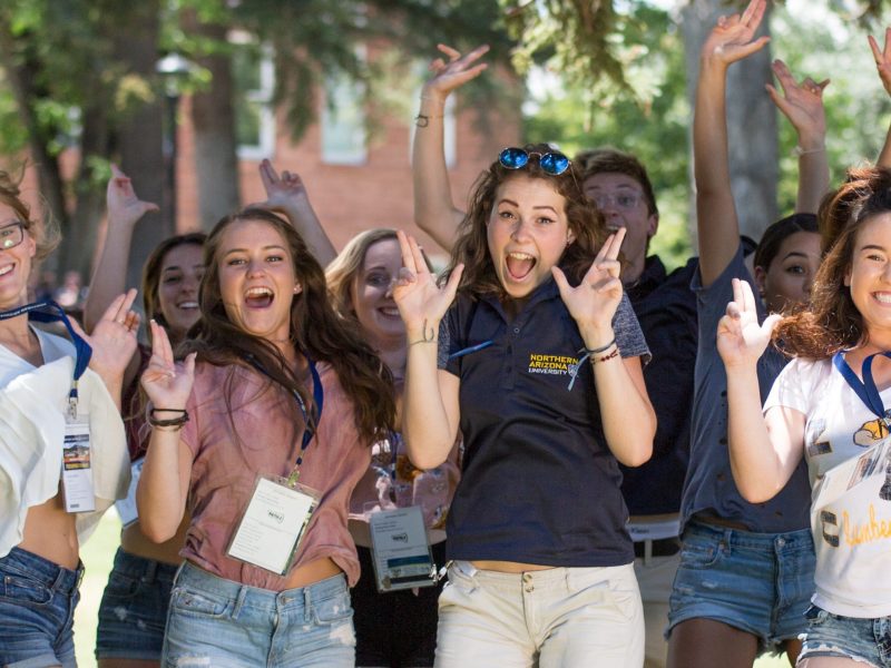 A group of students holding up LJs.