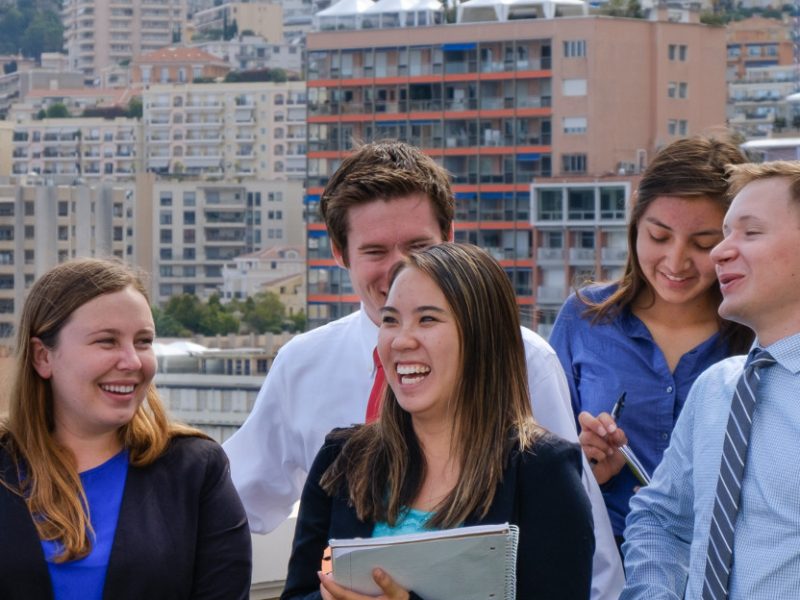 Students wearing business attire talking outside.