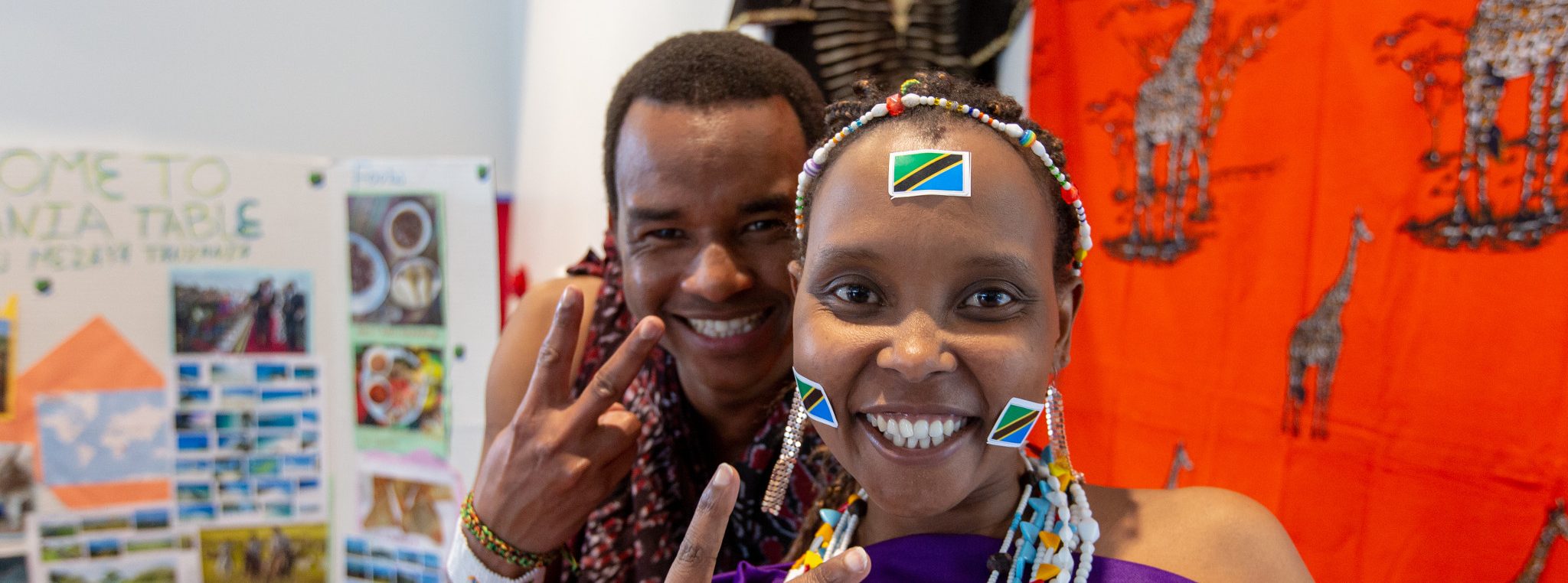 Students smiling while showing peace signs.