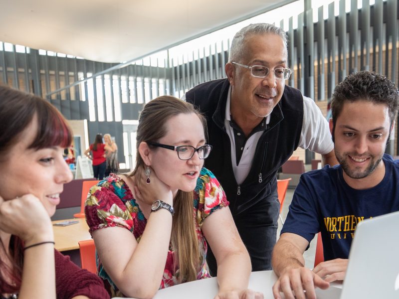 Students working together on a laptop.