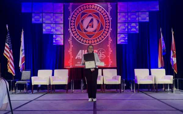 CARE's TA, Macie, receiving an award for her undergraduate research.