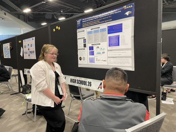 Sammy and their poster presentation.