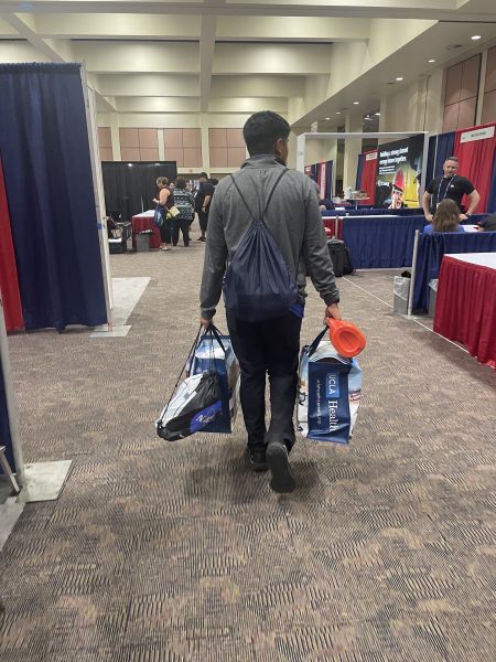 People carrying merchandise through event.