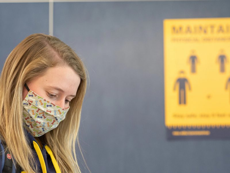 Student wears a mask on campus.